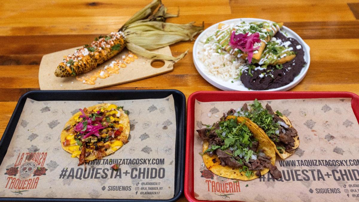 In clockwise direction, an Elote Mexican corn cob, enchilada with green sauce, a street taco, and a taquiza taco served at the new La Taquiza Mexican street food location on East Main Street, Nov. 17, 2022.