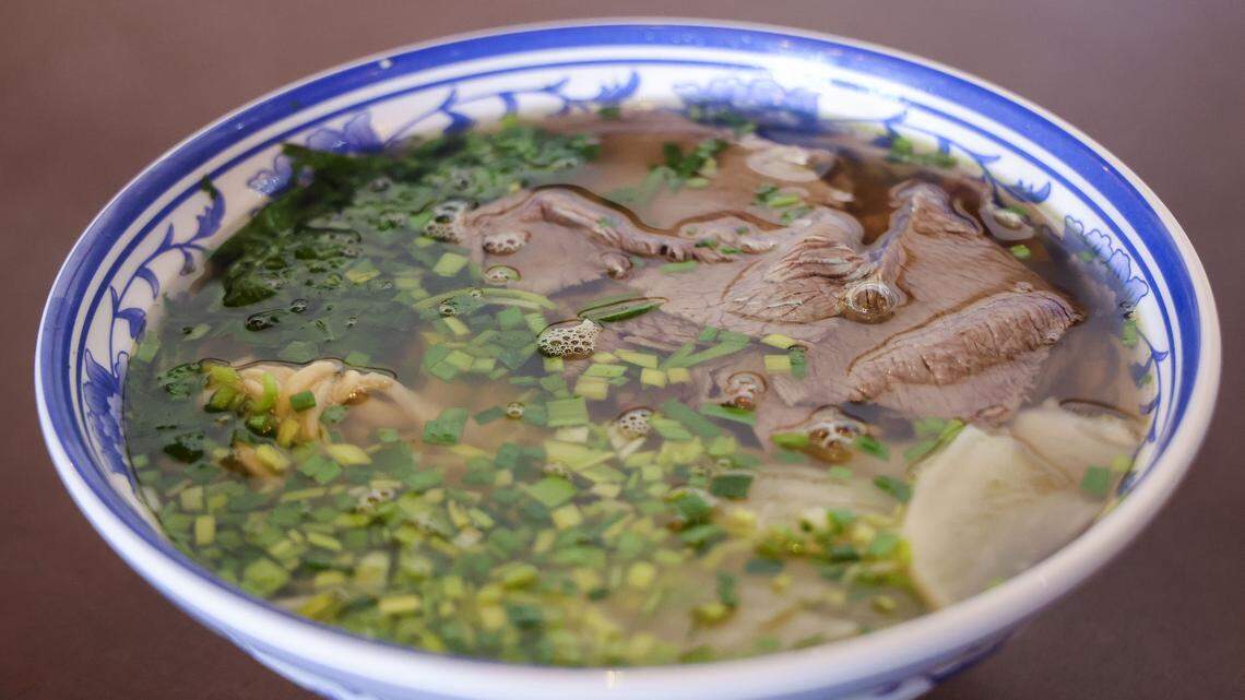 A hand-pulled noodle dish from Kung Fu Noodle, photographed Wednesday, Aug. 13, 2025, in Lexington, Ky. Lanzhou Beef-Noodle Soup which is served with braised beef slices, sliced white radish, green garlic, cilantro in a dark beef broth ($12.95). Owner Dennis Zhang said the classic Chinese dish is known for its homemade noodles, particularly the texture and the broth. “It's the soul of that dish.”