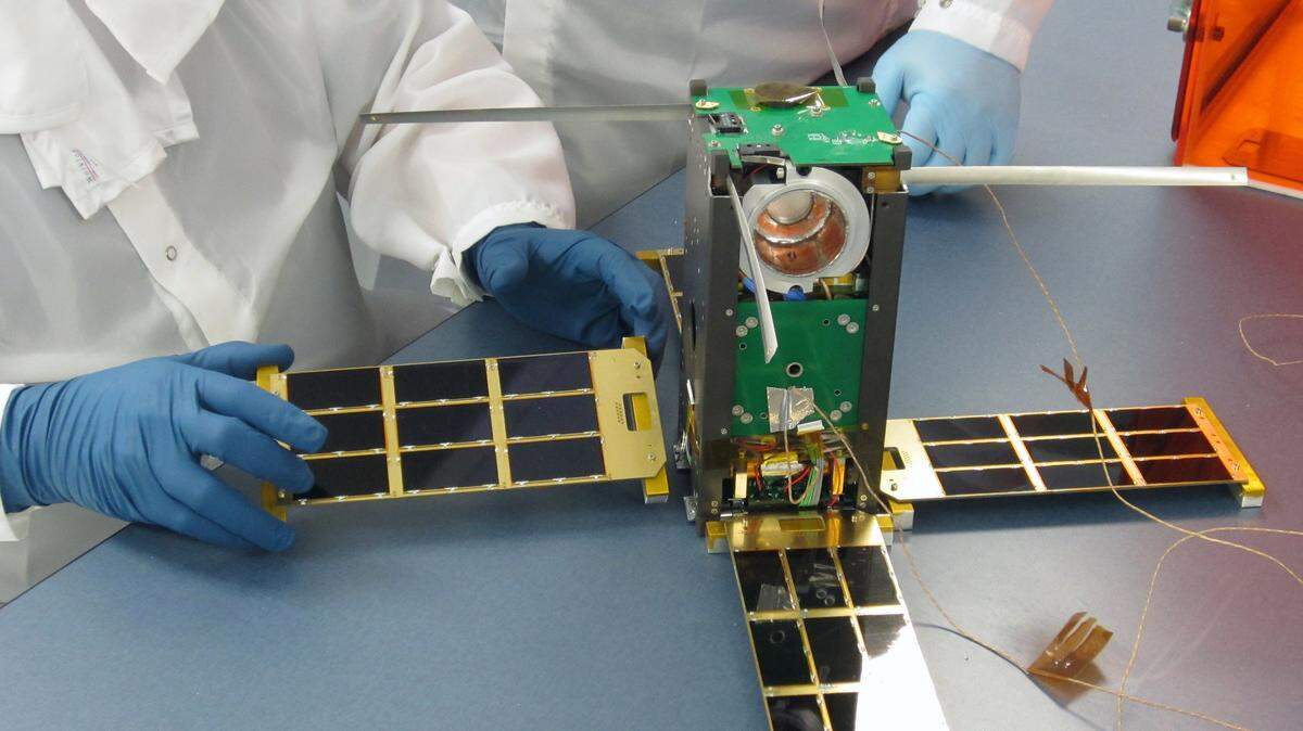 Morehead State researchers assembled solar panels on a CubeSat satellite. The university's Space Science Center has become a leader in designing and building small, high-tech spacecraft.  