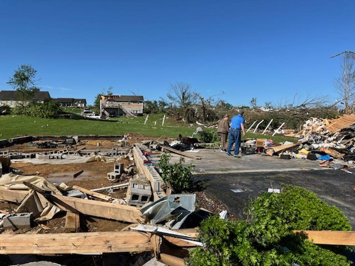 Jennifer Adams and her neighbor look through the remains of Adams’ house, which was ripped off its foundation by significant storms and a presumed tornado in the Sunshine Hills area of Laurel County early May 17, 2025.