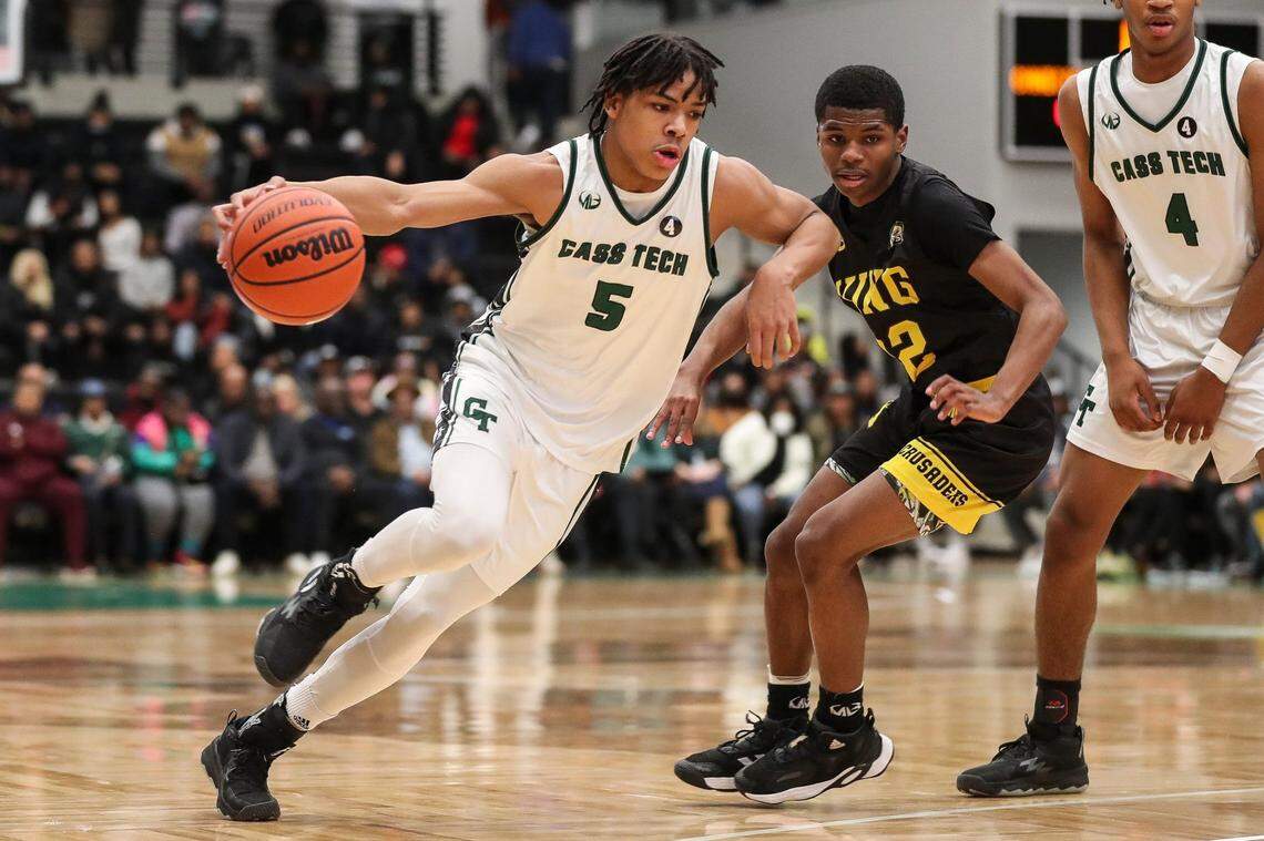 Cass Tech's Darius Acuff (5) dribbles against Detroit King's Daniel Hayes (22) during the first half at the Wayne State Fieldhouse in Detroit on Sunday, February 19, 2023.