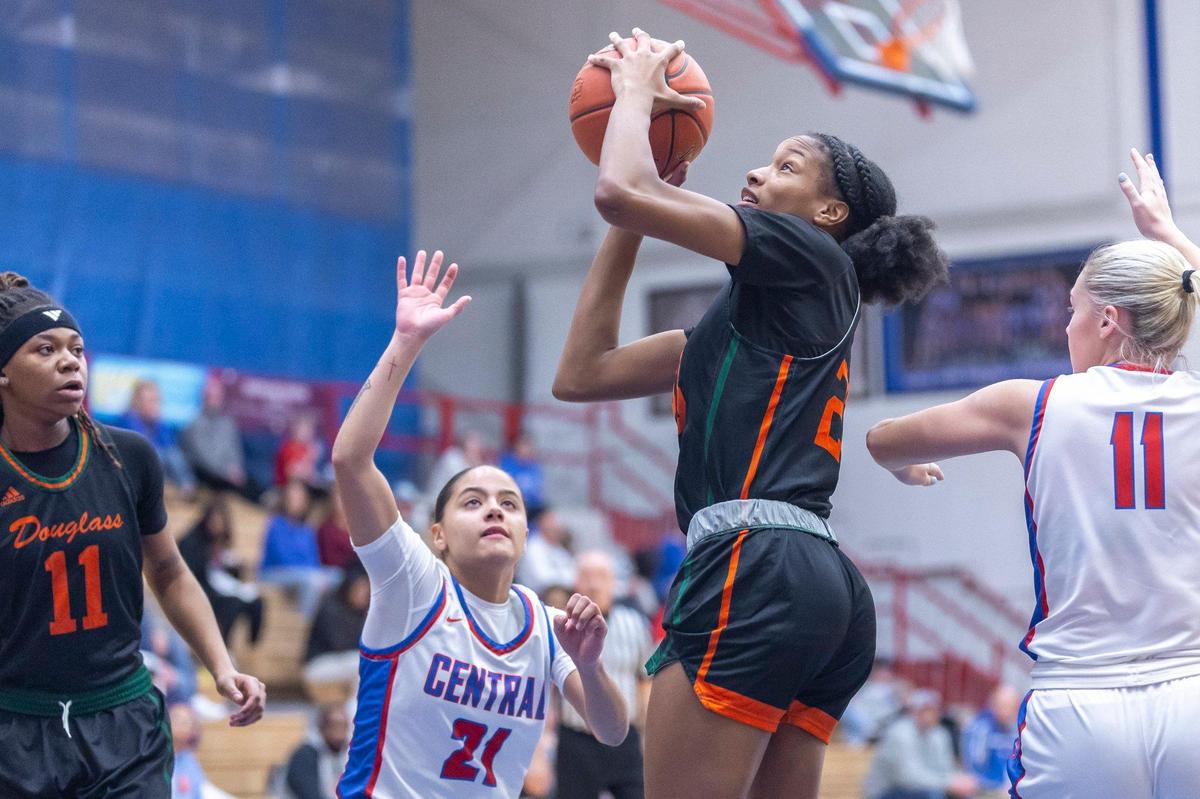 Frederick Douglass’ Jaelee Knowles, right, shoots the ball between the defense of Madison Central’s Nataya Strader (21) and Brittany Campbell during Friday’s game in Richmond.
