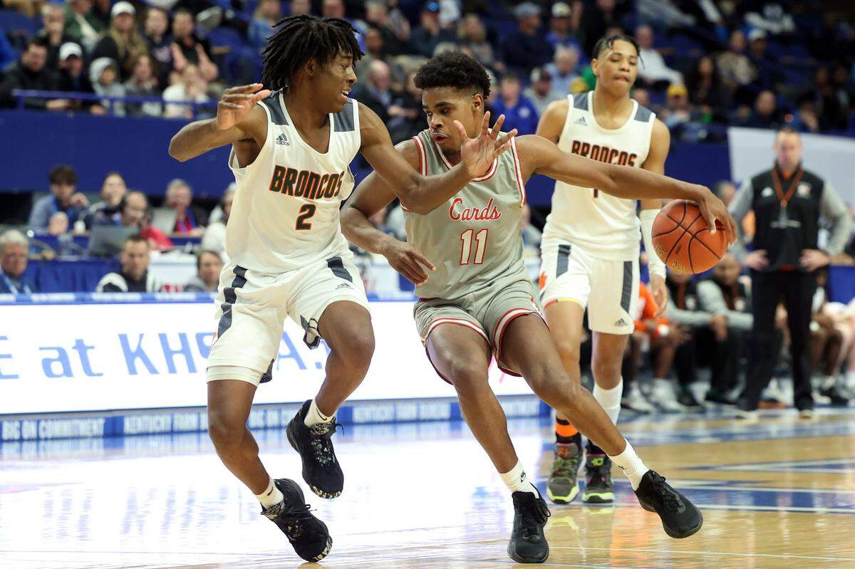 George Rogers Clark’s Jerone Morton (11) is defended by Frederick Douglass’ Aveion Chenault (2) during the Sweet 16 semifinals at Rupp Arena on Saturday.