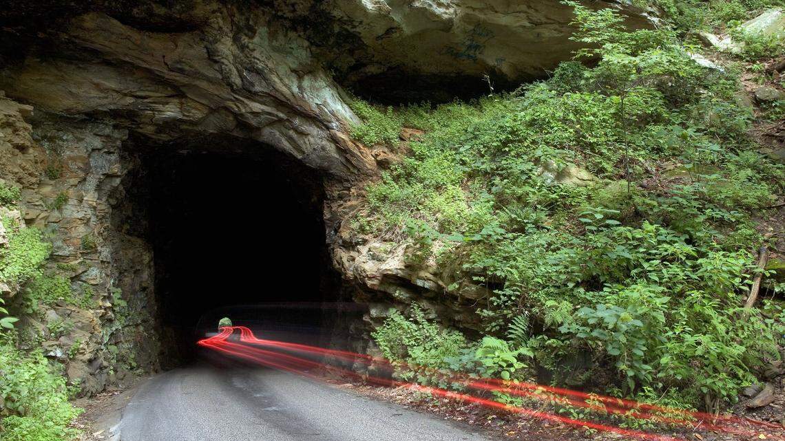 Built in the early 1900s so logs could be hauled out of the gorge by railroad, the 900-foot Nada Tunnel now allows one-lane traffic. A very long exposure in 2006 captured only the taillights of the vehicle making its way into the gorge.