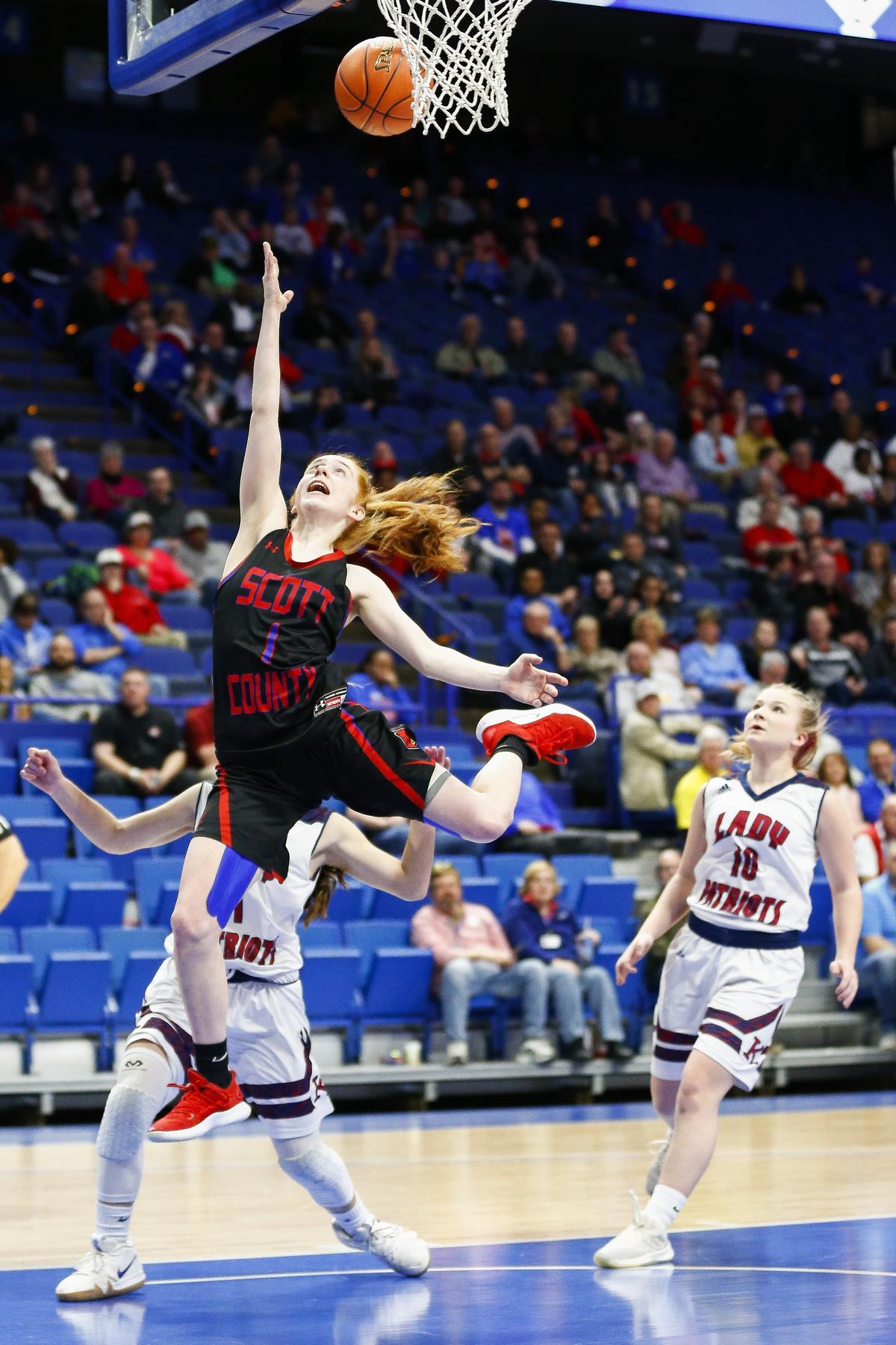 Scott County’s Morgan DeFoor (1) shot past Knott County Central’s Kylie Gayheart (1) during the first round of the KHSAA Girls’ Sweet Sixteen Wednesday at Rupp Arena in Lexington.