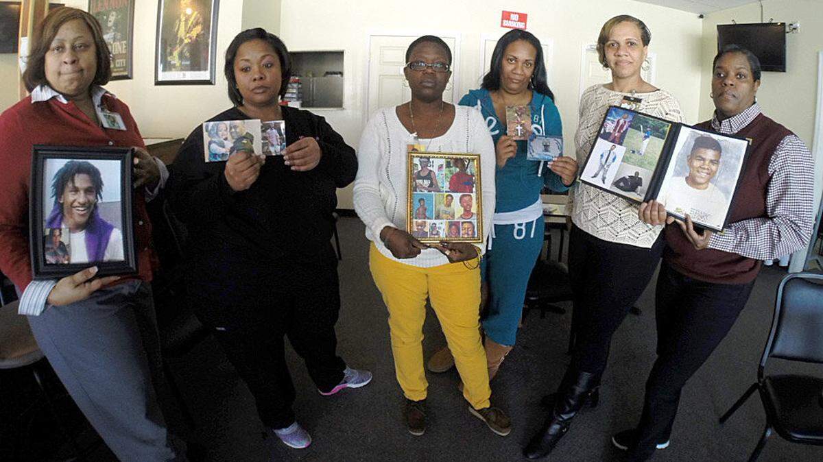 Six women held pictures of their slain loved ones at a press conference Tuesday announcing the establishment of their organization, Sisters and Supporters Working Against Gun violence. From left are Tammy Adams with son Jaleel Raglin, Chaka Travers with son Tyler Travers and nephew Rocardo "Teezy" Cole, Tonya Lindsey with son Ezavion Lindsey, Andrea Crocker with son Johntel "Pudd" Crocker, Latosha Reynolds with son Steven Lee Reynolds, and Quantella Higgins with boyfriend Ronnie Lee Smith.        