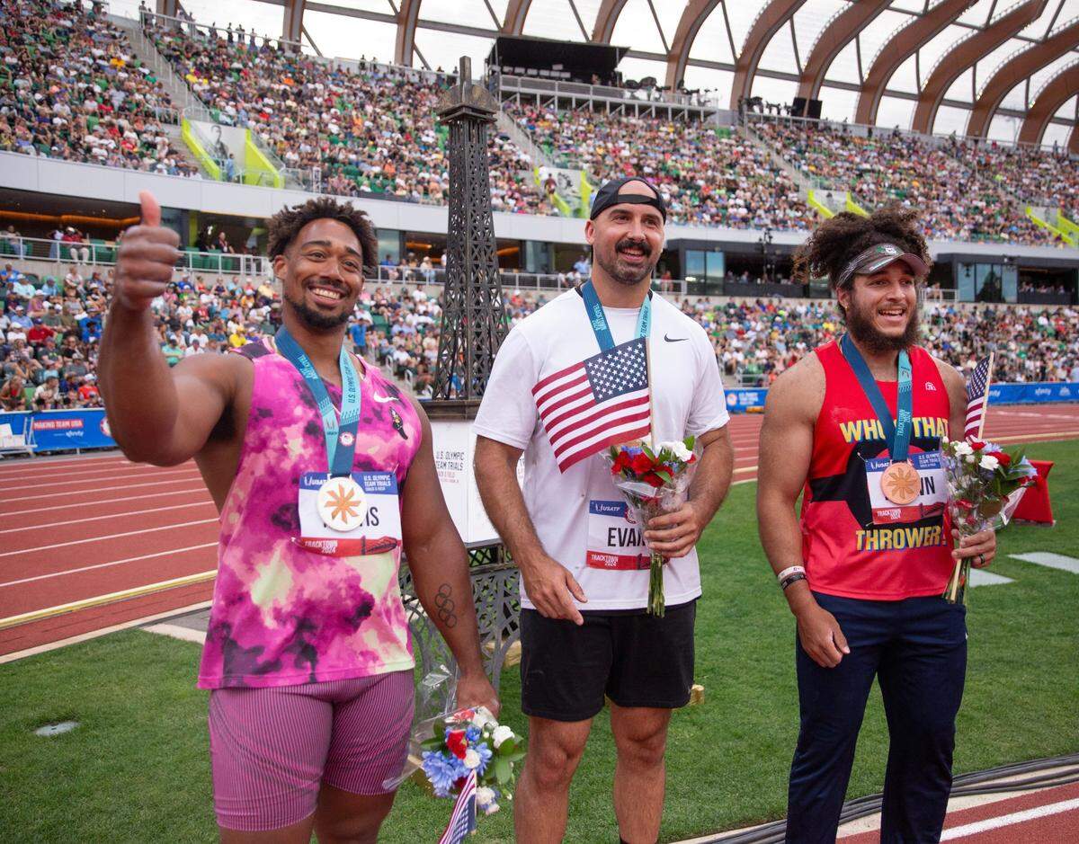 Silver medalist Sam Mattis, left, joins champion Andrew Evans and bronze medalist Joseph Brown celebrates at the Eiffel Tower on day 9 of the U.S. Olympic Track and Field Trials at Hayward Field in Eugene Saturday, June 29, 2024.