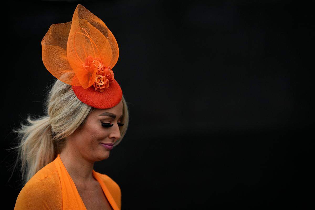 A woman walks to her seat on the day of the 149th running of the Kentucky Derby at Churchill Downs Saturday, May 6, 2023, in Louisville, Ky. (For the Herald Leader/Bryan Woolston)