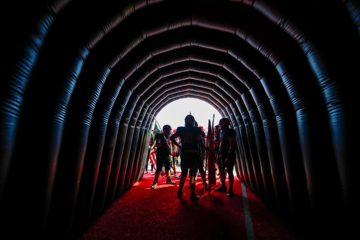 The Scott County Cardinals huddle in their run-out tunnel before team introductions.