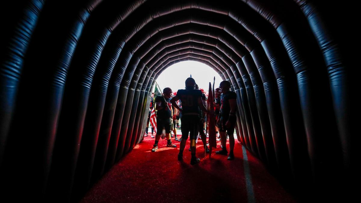 The Scott County Cardinals huddle in their run-out tunnel before team introductions before the game with the Frederick Douglass Broncos at Birds Nest Stadium at Great Crossing High School in Georgetown, Ky., Friday, September 23, 2022.