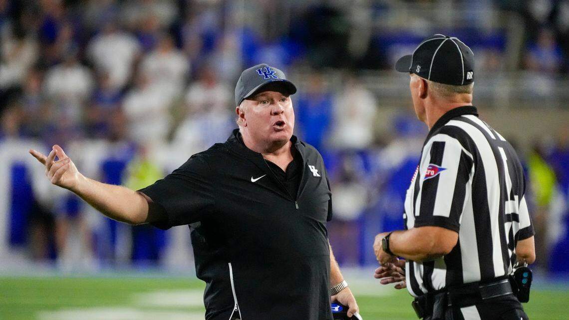 Kentucky head coach Mark Stoops speaks to an official during Saturday’s game against Georgia.