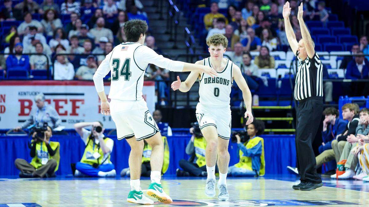 South Oldham’s Jake Fithian (0) celebrates one of his five made 3-pointers with Brooks Bee (34). Fithian scored a game-high 17 points.