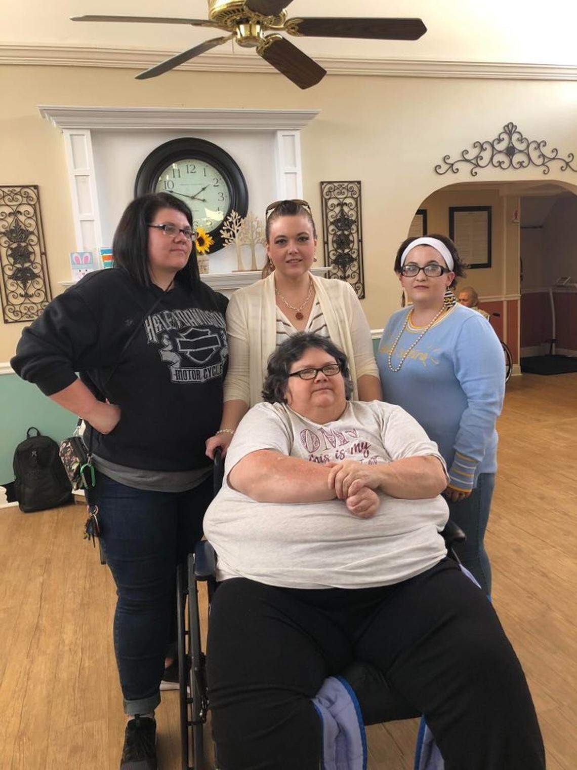 From left, Kelly McElhose, Jamie Smith and Kayla Stephens stand behind their mom, Sharon Smith, in the Prestonsburg Health Care Center earlier this month for Sharon’s birthday. Gov. Andy Beshear on Tuesday recommended that long-term care facilities temporarily suspend all visitation to patients to avoid spread of the novel coronavirus.