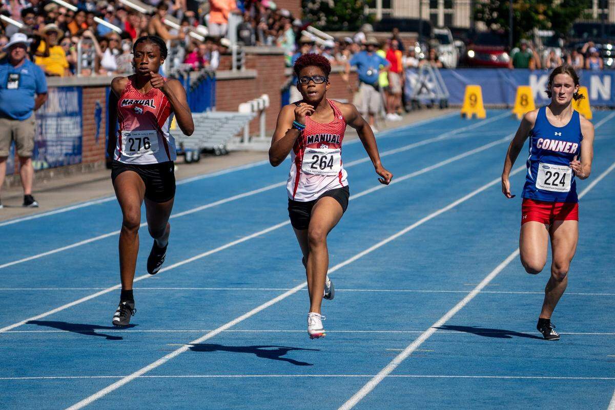 Alexandra Allen of Manual, middle, wins the 100-meter dash during this month’s state track and field championships in Lexington. In addition to the 100, Allen won the 200 and the 400 and was part of her team’s winning 4-by-400 relay.