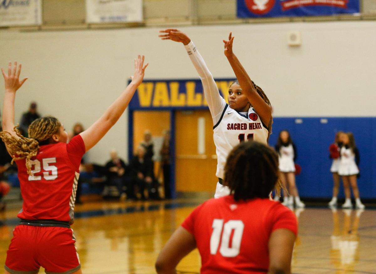 Sacred Heart’s ZaKiyah Johnson makes a 3-pointer against Butler’s Mariah Knight in the Republic Bank Girls LIT Championship game on Saturday.