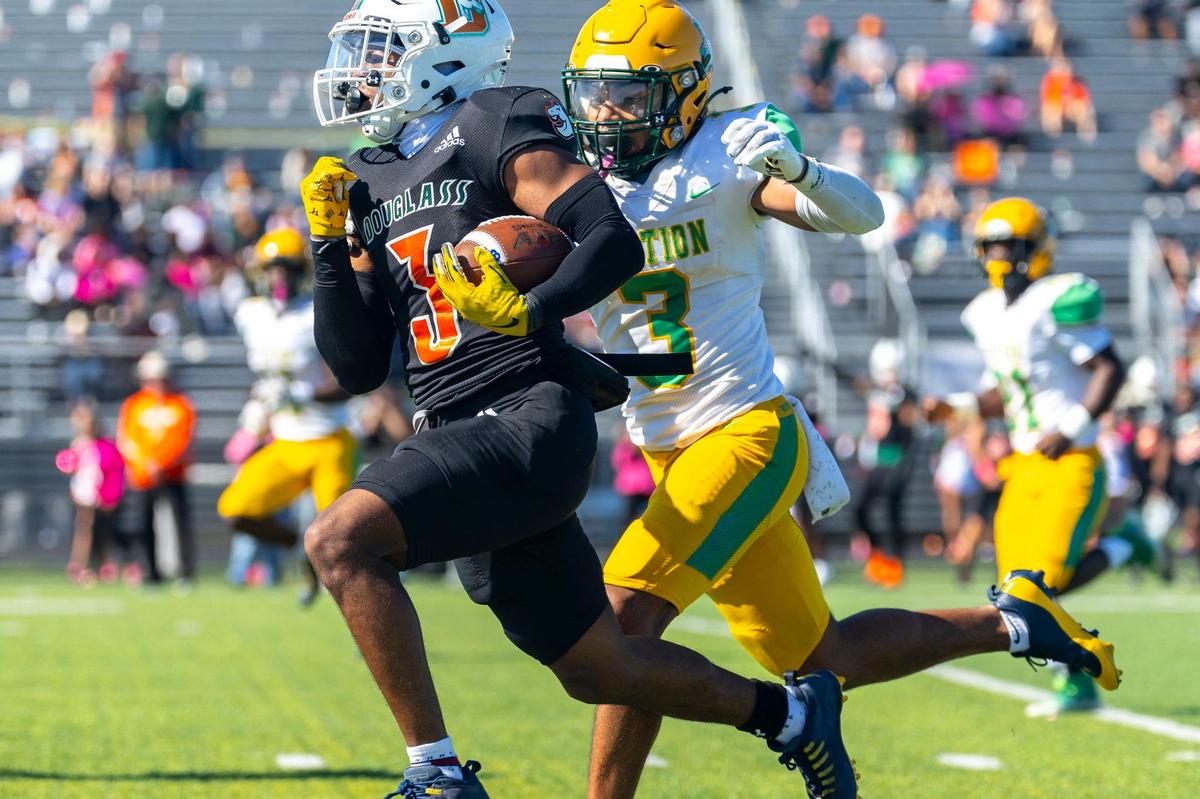 Frederick Douglass’ Pharo Watts (3) tries to escape the pursuit of Bryan Station’s Jordan Haskins (3) during their regular-season game at Frederick Douglass High School on Oct. 19. Both begin the playoffs as favorites this week.