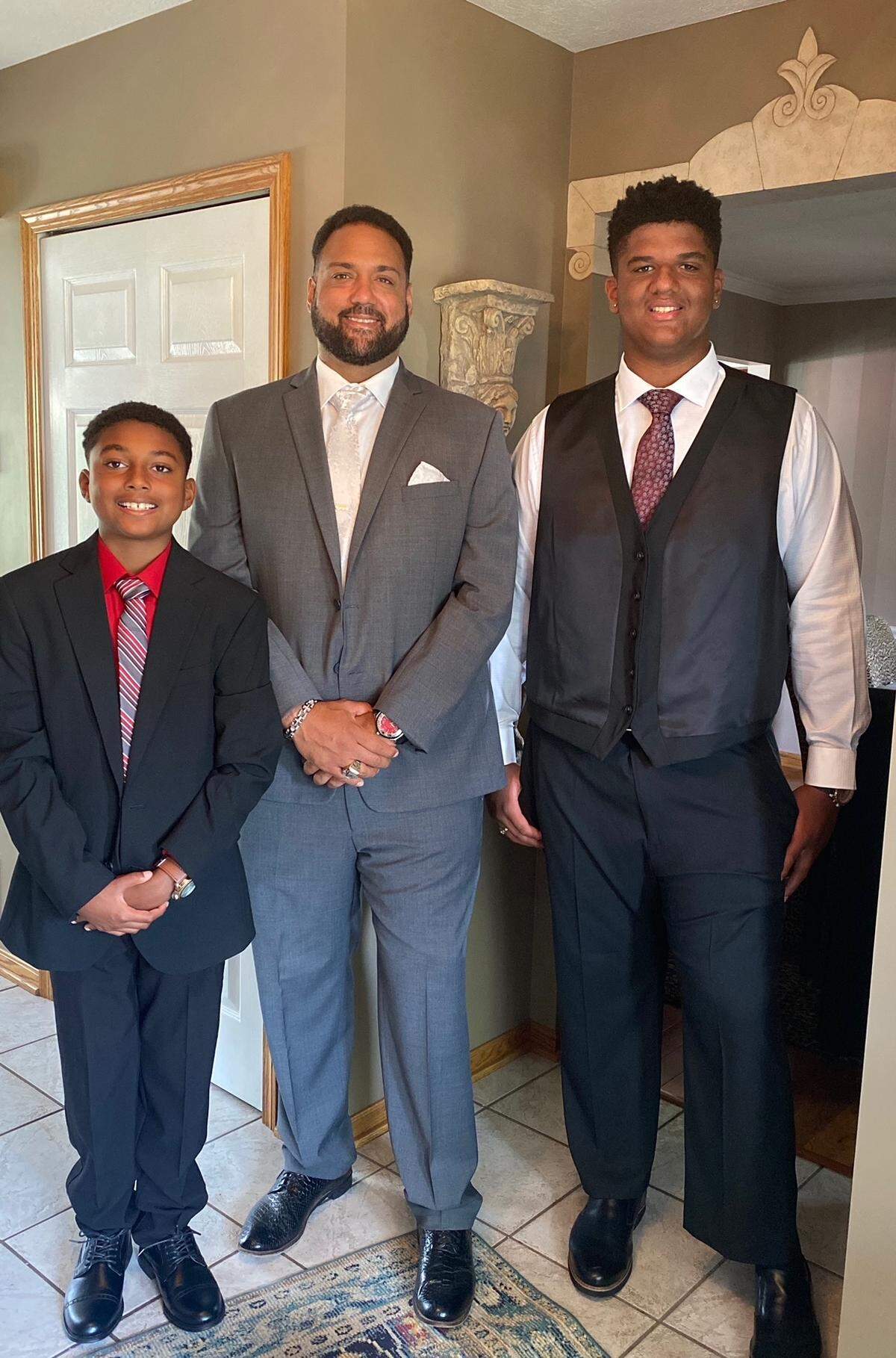 Former UK football player Antonio Hall, center, stood with his two sons, Noah Hall, left, and Nikolas Hall, right.