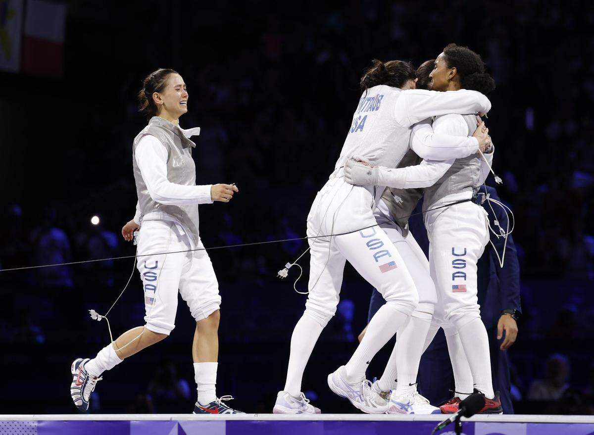 Aug 1, 2024; Paris, France; Lee Kiefer, Lauren Scruggs, Maia Mei Weintraub and Jacqueline Dubrovich (USA) celebrate winning the gold medal in the women's team foil competition during the Paris 2024 Olympic Summer Games at Grand Palais. Mandatory Credit: Yukihito Taguchi-USA TODAY Sports