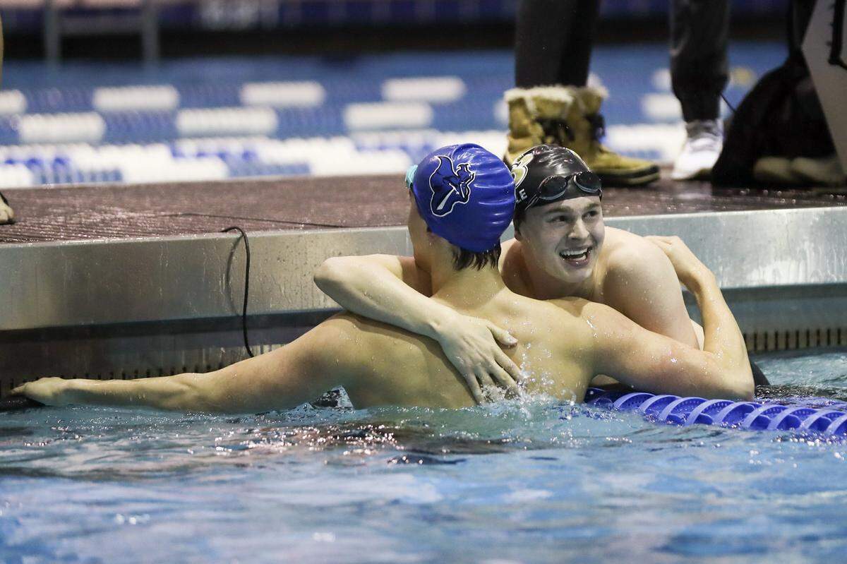 Boyle County’s Clark Coyle, right, won the 50 freestyle and was congratulated by Lexington Catholic’s Wil Jones, who finished third in a tight race at KHSAA Boys State Swimming Championships at the University of Kentucky’s Lancaster Aquatic Center on Friday.