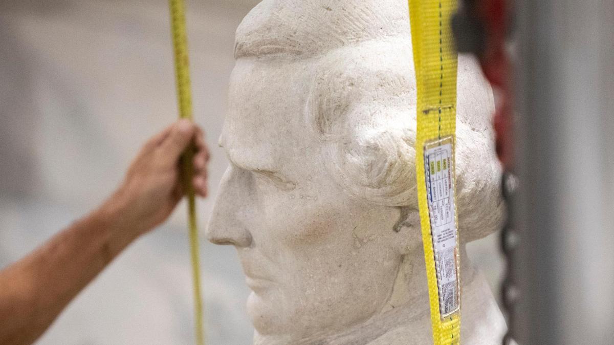 Workers prepare to remove the Jefferson Davis statue from the rotunda at the Kentucky state Capitol in Frankfort, Ky., on Saturday, June 13, 2020.