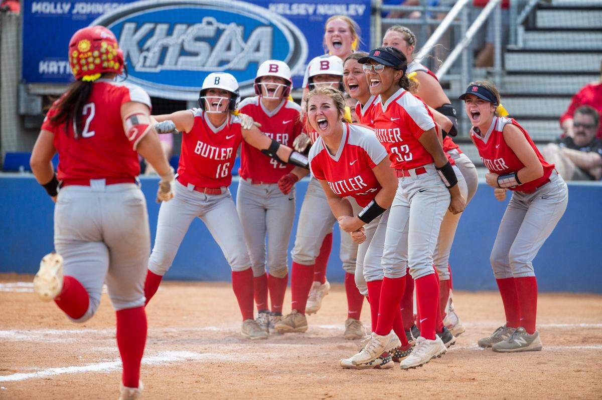 The Butler Bearettes celebrated at home plate after Kyndal Tinnell (12) hit a grand slam against Daviess County during the KHSAA State Softball Championship at John Cropp Stadium.