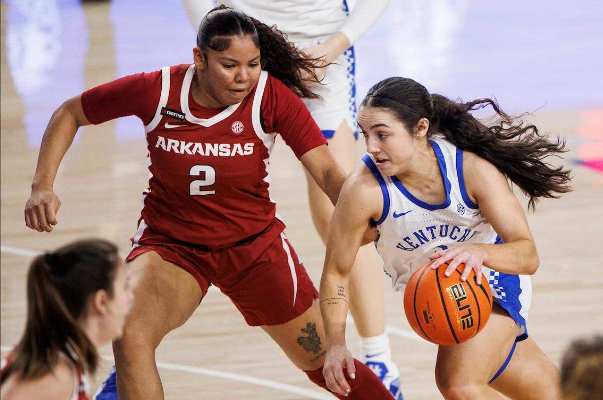 Kentucky’s Georgia Amoore, right, dribbles the ball against Arkansas during the Wildcats’ 89-69 win at Memorial Coliseum in Lexington, Ky., on Sunday, Jan. 26, 2025.