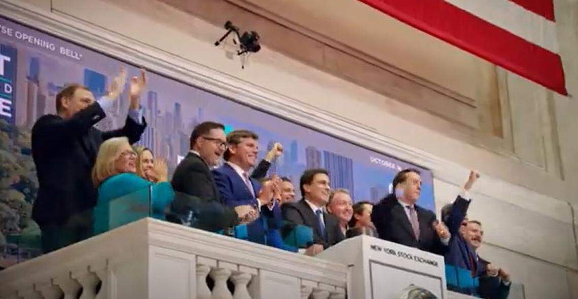 Nate Morris (center, at microphone) and other Rubicon Technologies executives celebrate at the New York Stock Exchange as the company starts selling its shares to the public in 2022.
