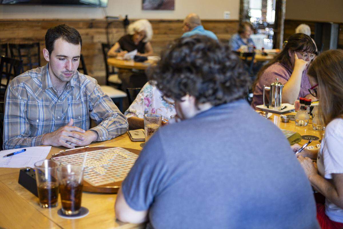 Mack Meller, left, plays against Fred Morlen during a Scrabble club meeting on Sunday, July 27, 2025, at Sedona Taphouse in Lexington, Ky.