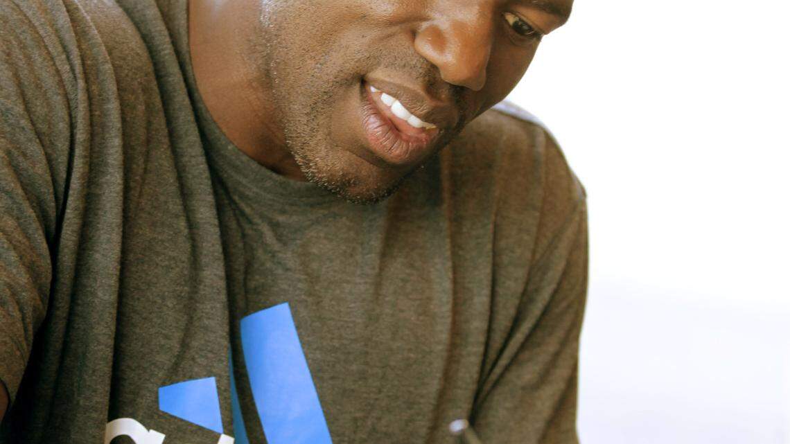 Tony Delk signed a poster for a fan.  Delk was a three-time All-SEC selection during his four years as a basketball player at Kentucky.