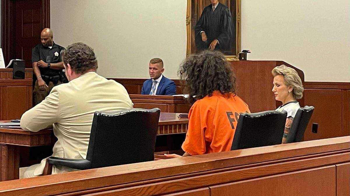 Justin Brown (middle), appears next to his attorney Ben Church (left). He faces murder and other charges connected to the July shooting which killed Stacey Marshall.