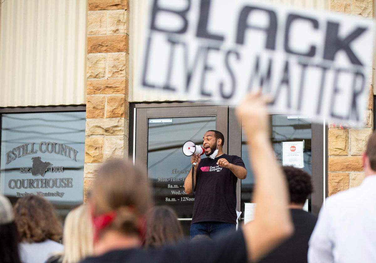 Rep. Charles Booker speaks to the crowd of protesters gather in front of the Estill County courthouse during a Black Lives Matter protest in Irvine, Ky., Monday, June 8, 2020.