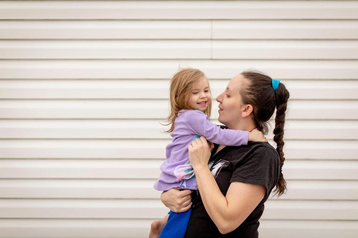 Jessica Blakeman holds her daughter outside her trailer at the North Fork Mobile Home Park in Morehead, Ky., Thursday, February 4, 2021. Blakeman is a single mother who lived in the park with her 3 children.
