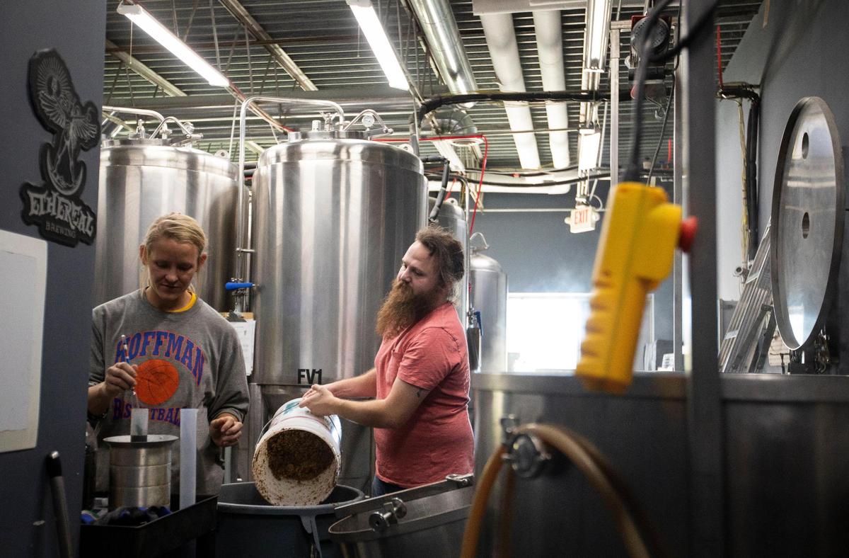 Head brewer, Patrick Fannin, and assistant brewer Maggie Wilder work on kegging some of their brews Nov. 16 at the Dreaming Creek Brewery. The Madison County brewery has 20 craft brews on tap.