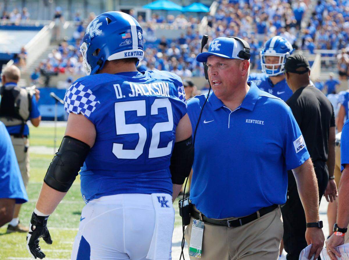 John Schlarman talked with center Drake Jackson during Kentucky’s win over Toledo at Kroger Field last year.