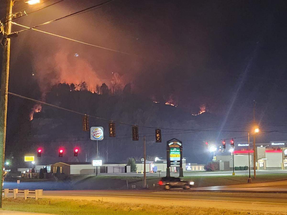 Photos show smoke and flames visible from Hazard roads as firefighters deal with dozens of forest fires in Eastern Kentucky. 