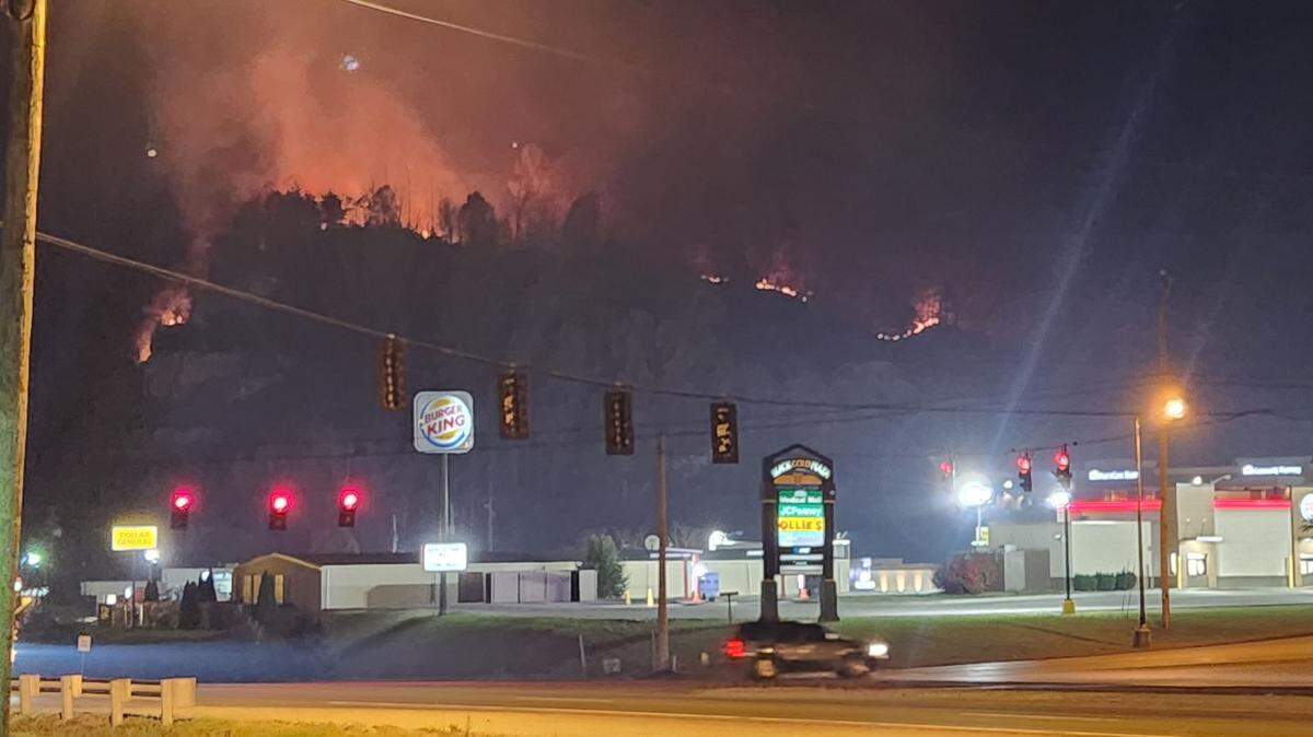 Photos show smoke and flames visible from Hazard roads as firefighters deal with dozens of forest fires in Eastern Kentucky.