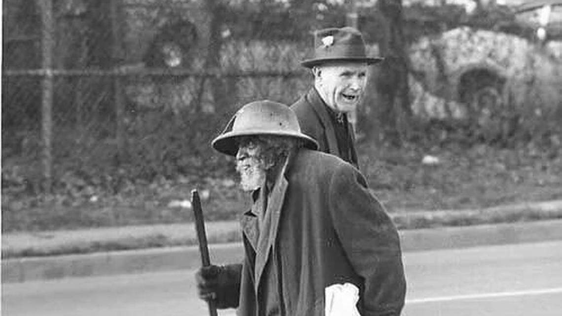 Joe Pellman, foreground, was a common sight around Nicholasville until his death in 1976. He hauled away junk and did other odd jobs for residents, and often pushed a cart around town.