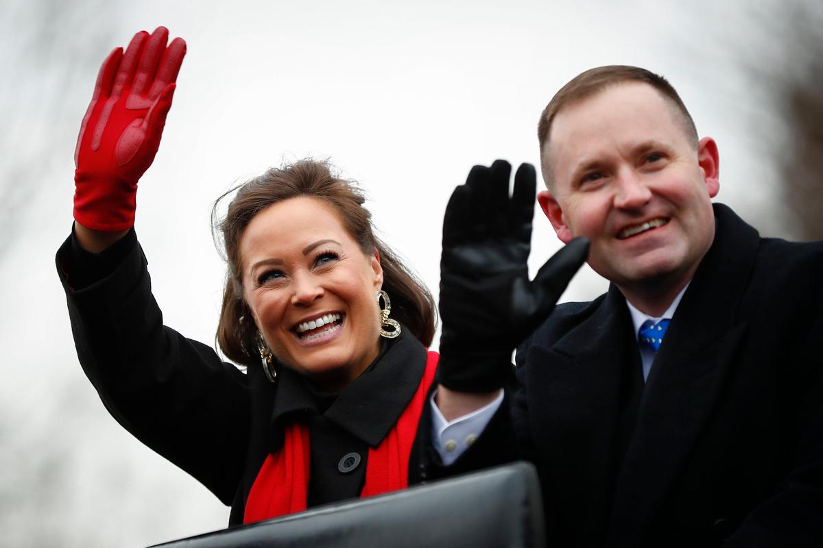 Lt. Gov. Jacqueline Coleman and her husband Chris O’Bryan wave to supporters during the inaugural parade at the state Capitol in Frankfort, Ky., Tuesday, Dec. 10, 2019.