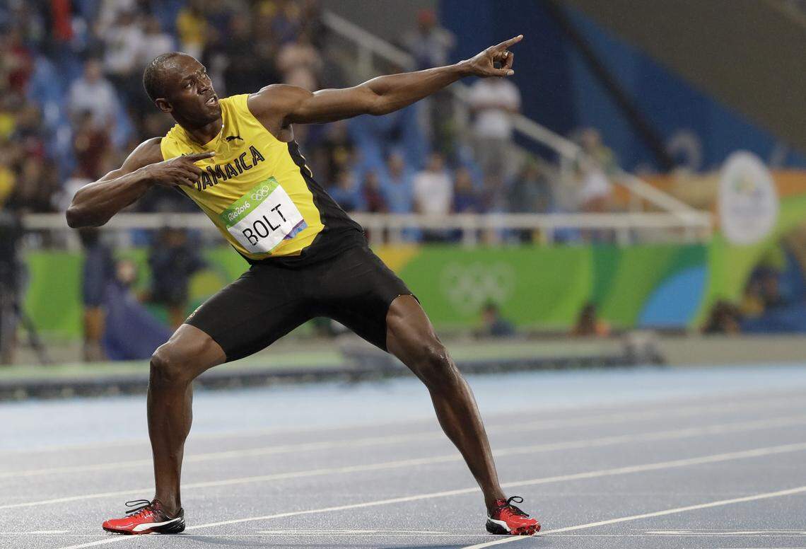 FILE - In this Aug. 18, 2016, file photo, Usain Bolt, from Jamaica, celebrates winning the gold medal in the men's 200-meter final during the athletics competitions of the 2016 Summer Olympics at the Olympic stadium in Rio de Janeiro, Brazil.  (AP Photo/David J. Phillip, File)