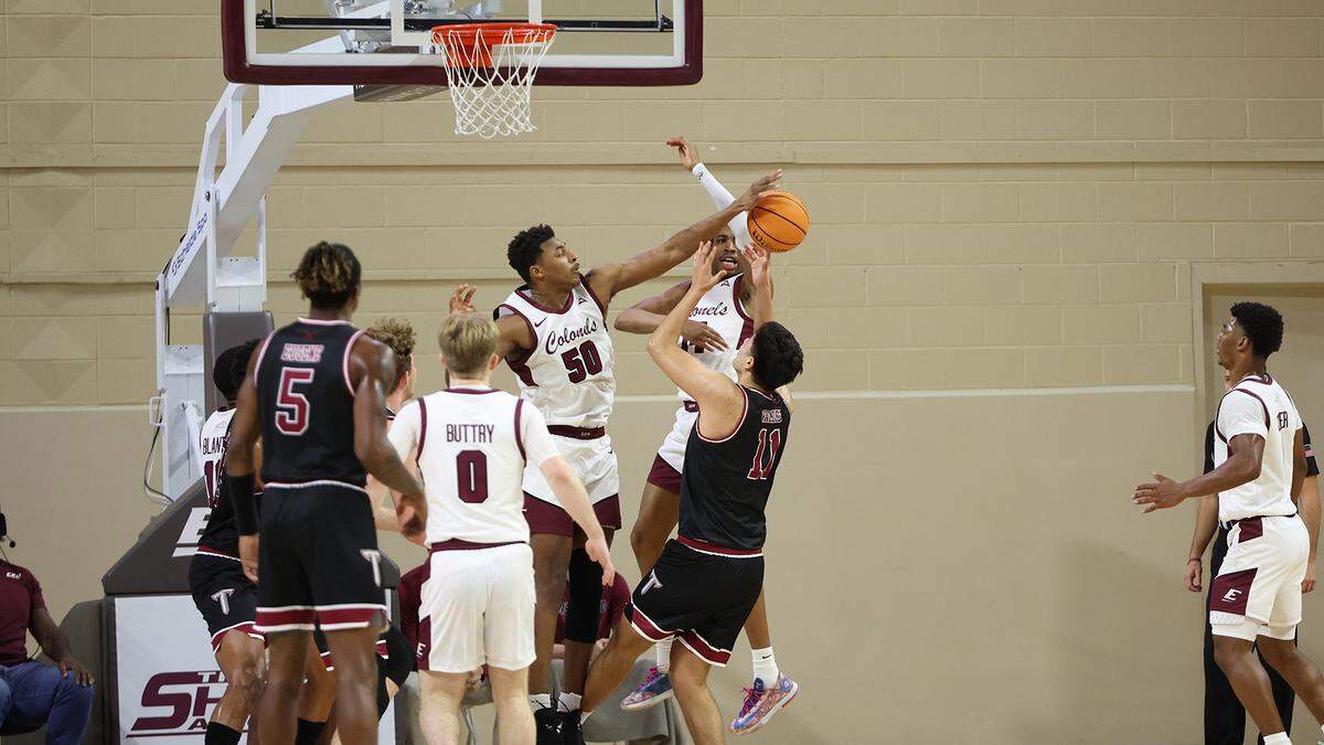 Eastern Kentucky senior center Isaiah Cozart blocks a shot against Troy in Richmond on Monday night. Cozart recorded a points, rebounds and blocks triple-double in the Colonels win, which marked the first triple-double in EKU men’s basketball history.