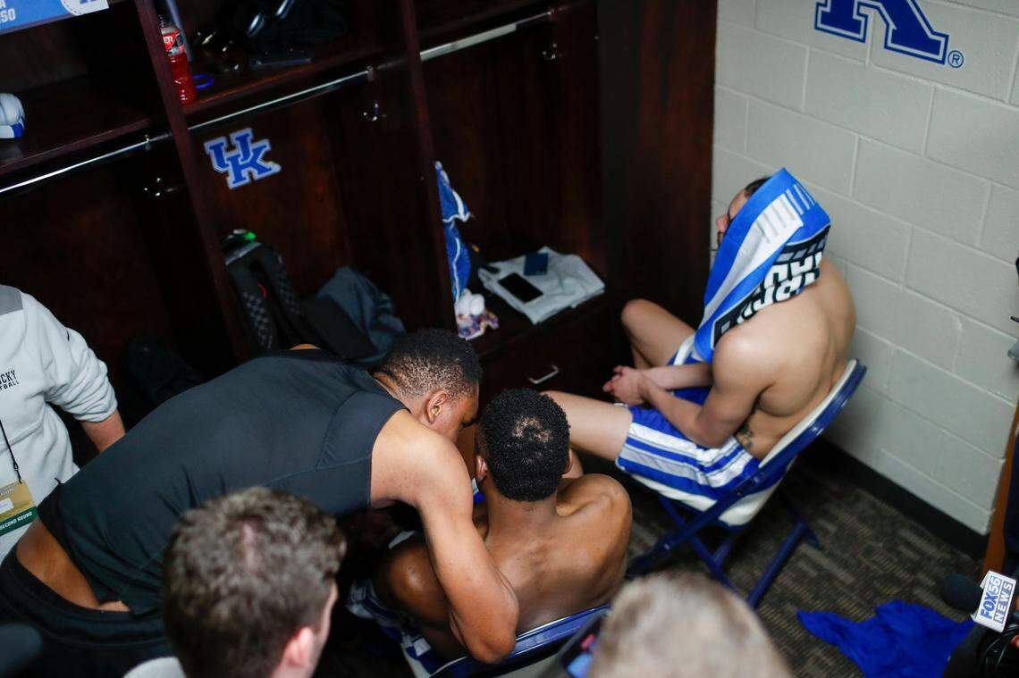 Kentucky forward Ugonna Onyenso, left, talks with forward Oscar Tshiebwe while forward Lance Ware has a towel over his head in the locker room after Sunday’s NCAA Tournament loss to Kansas State.