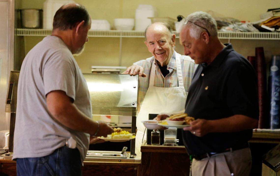 Max Flannery chatted with longtime customers Paul Whitaker, left and Steve Peyton at Loudon Square Buffet in Lexington, Ky, on Aug. 24, 2016. Flannery served locals at the buffet from 1974 to 2022, 365 days a year.