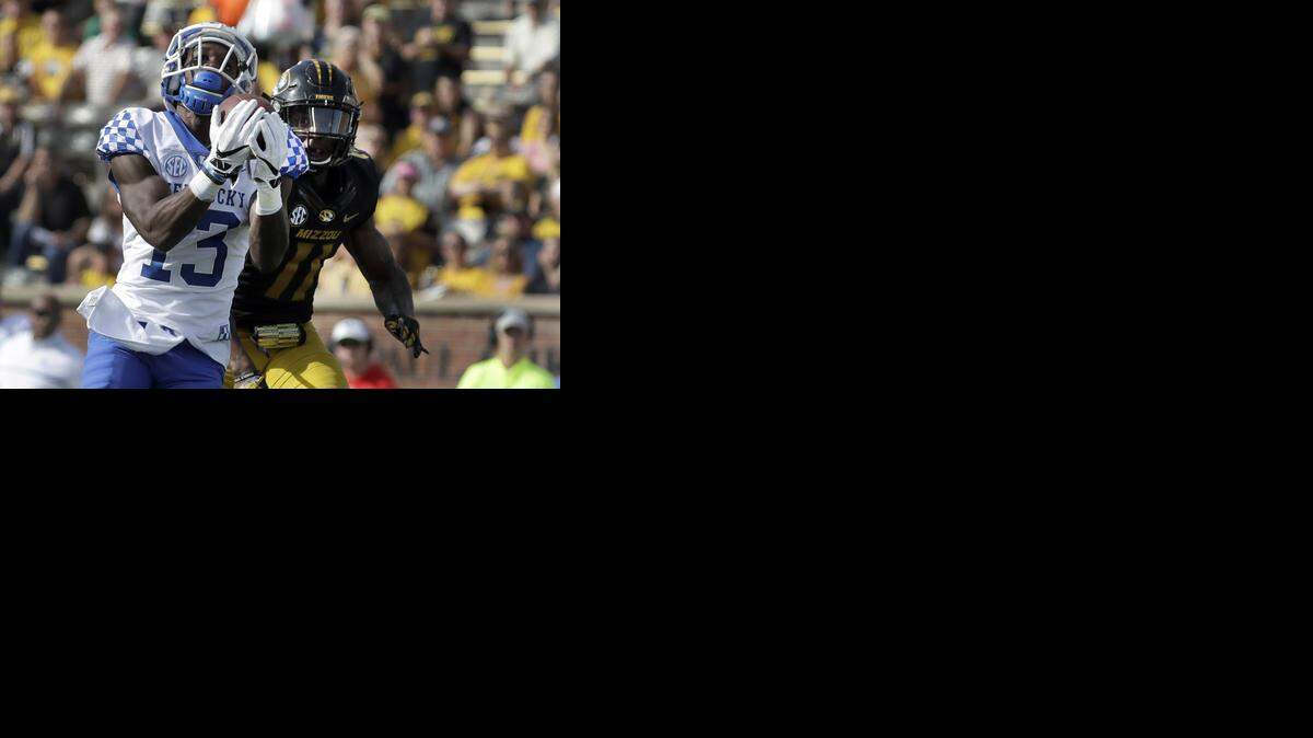 Kentucky wide receiver Jeff Badet, left, caught a 65-yard touchdown pass as Missouri defensive back Aarion Penton defended during the first half on Saturday in Columbia, Mo.