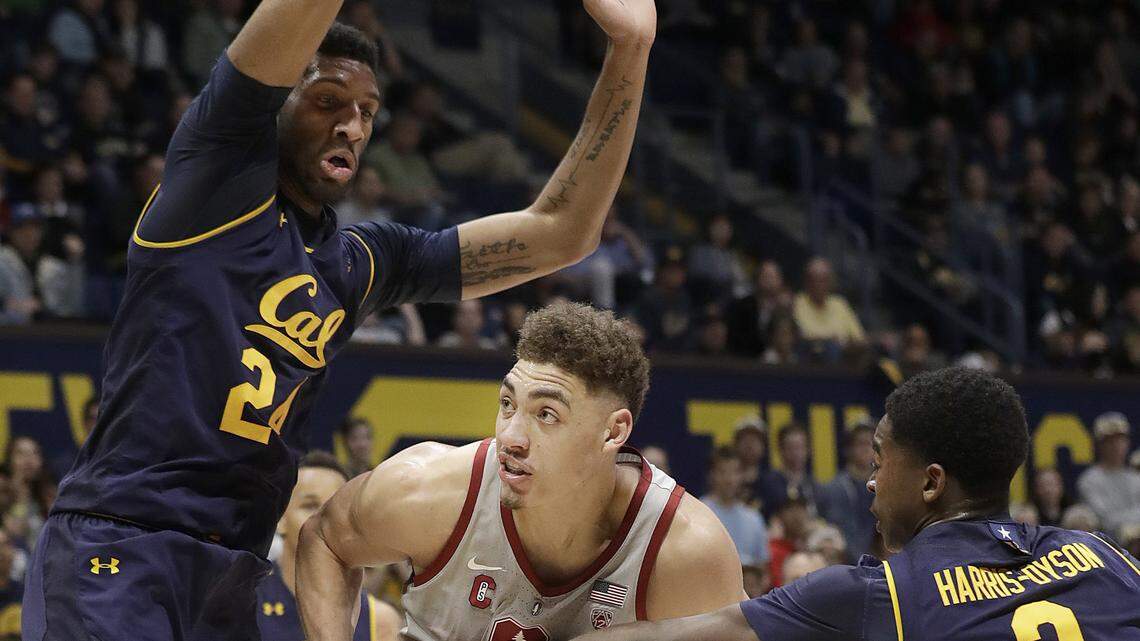 Stanford's Reid Travis, center, was guarded by California's Marcus Lee, left, and Juhwan Harris-Dyson during the first half of a game in Berkeley, Calif., on Feb. 18, 2018.