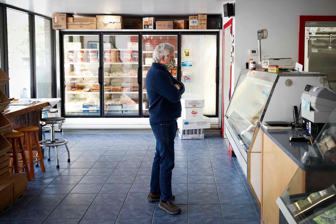 John Winn Mille waits for his order and browses fish for sale in the cooler Tuesday at the Lexington Seafood Company. The Lexington Seafood Company usually offers lunch to customers, but has suspended service due to the coronavirus pandemic.