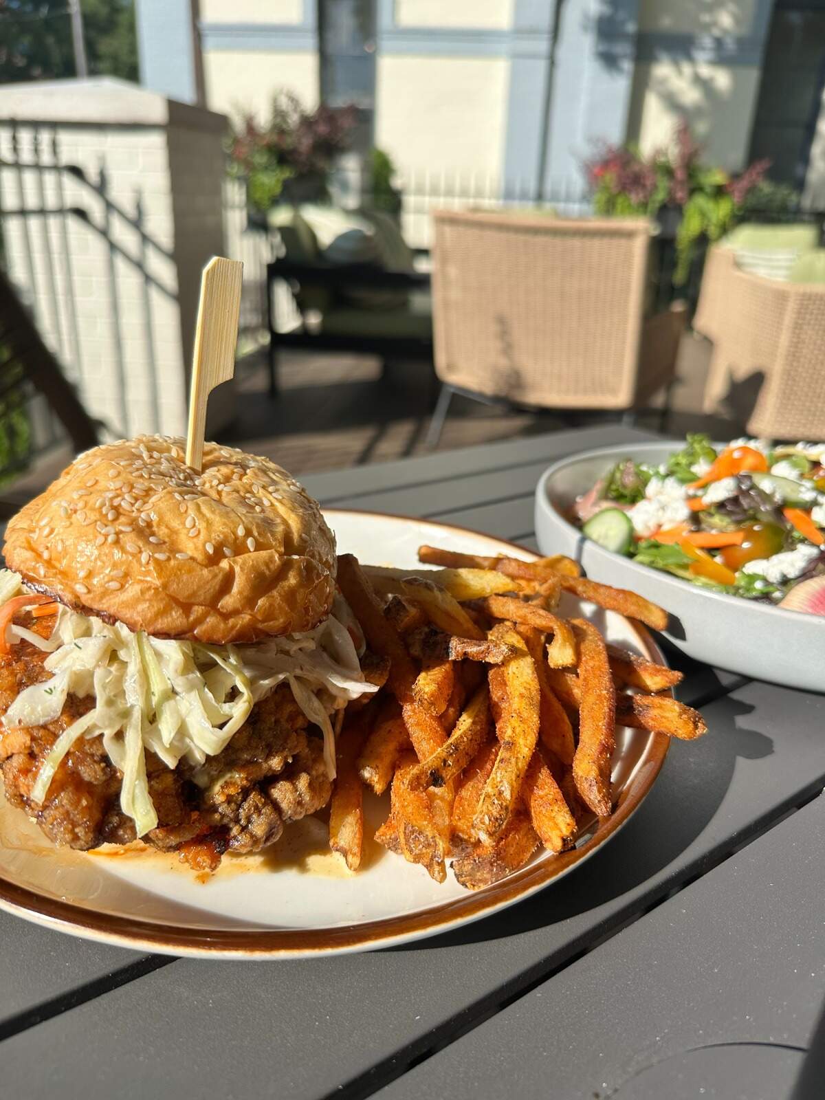 The crispy chicken sandwich is made with a buttermilk fried chicken thigh, hot honey, dill-pickle slaw, tomato, house roll and served with seasoned fries ($17) at Millstone.