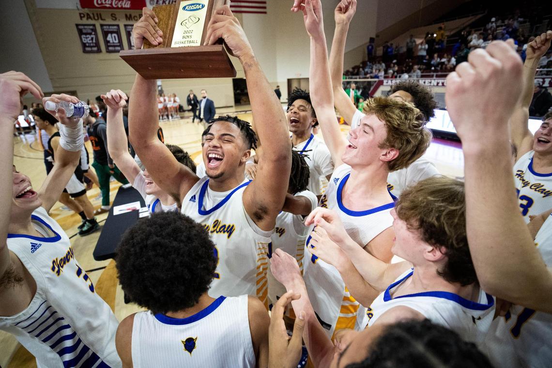 Henry Clay’s Kyan Miller holds up the team’s trophy after it defeated Frederick Douglass in the 11th Region boys’ championship game on March 7.