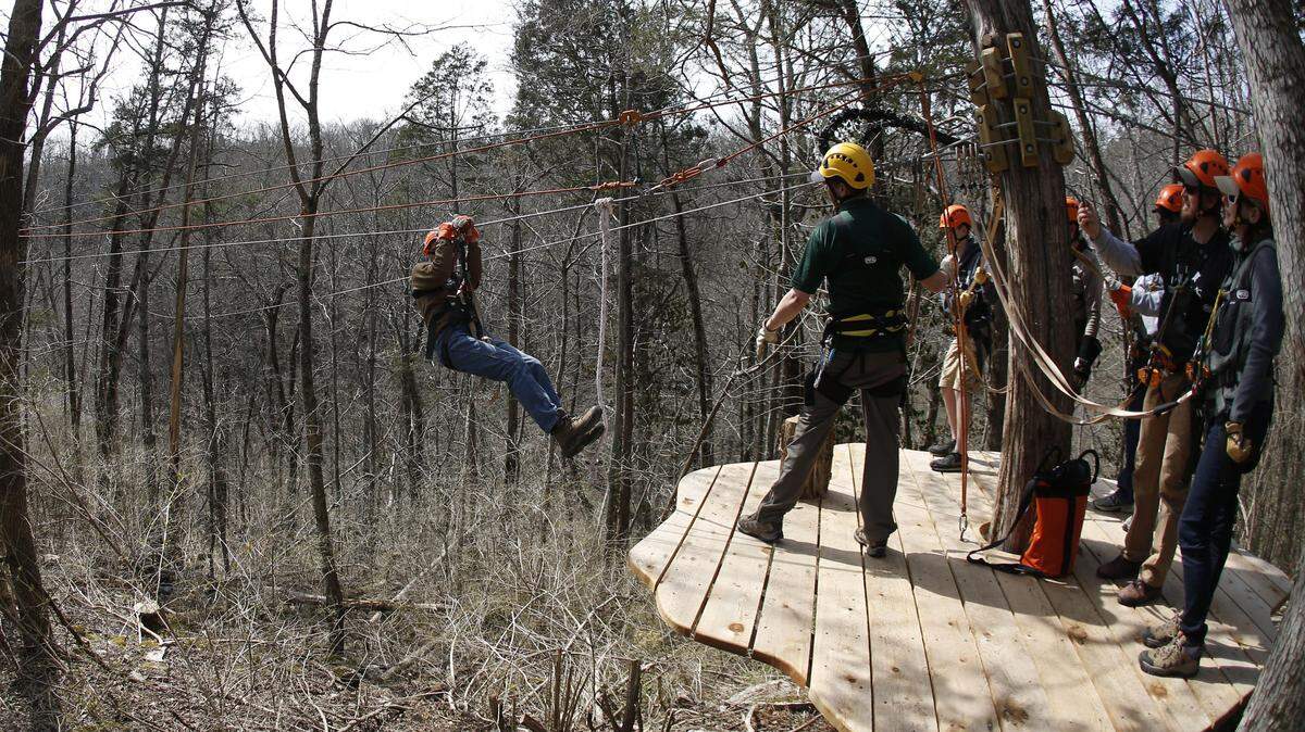 As they neared a  platform riders applied the brakes during a zip-line tour last March at Boone Creek Outdoors. The tour has been closed since August because of zoning issues. 