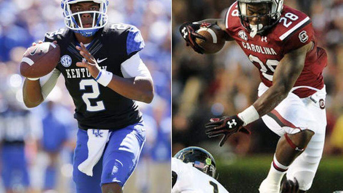 Kentucky quarterback Jalen Whitlow, left, and South Carolina running back Mike Davis
