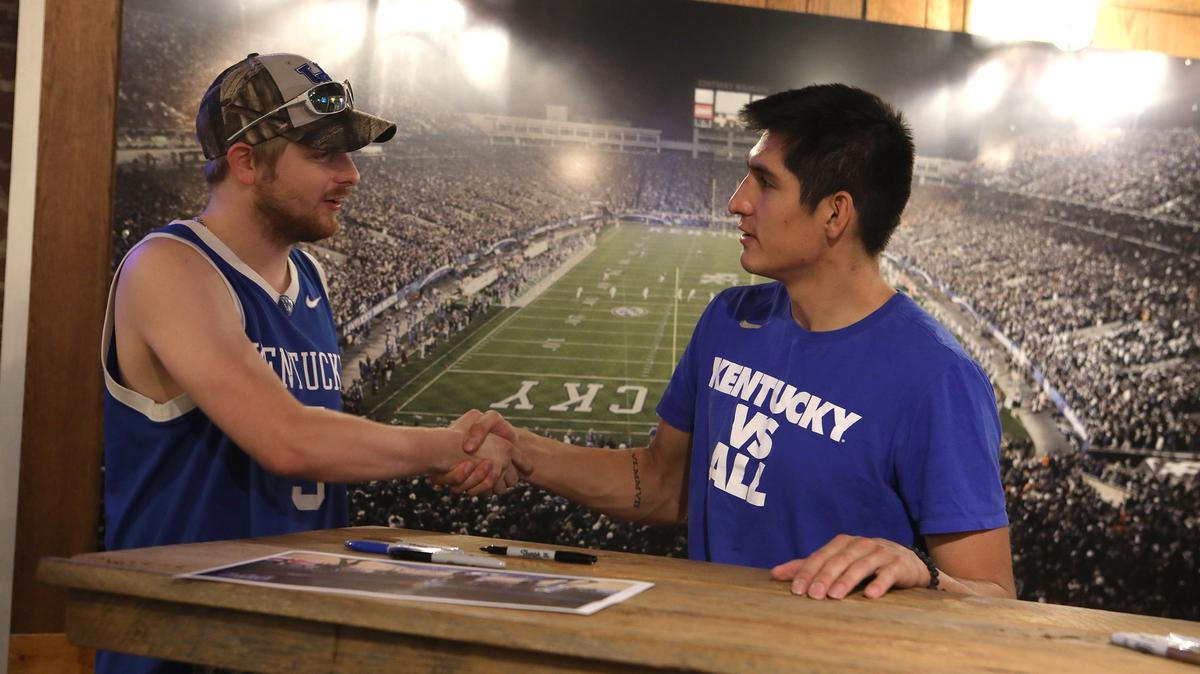 Ryan Neely of Georgetown shook hands with former UK player Derek Willis Tuesday during an autograph session at Wildcat Wearhouse. Photo by Matt Goins